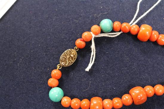 A carved jade, coral and hardstone bead necklace with silver gilt clasp, 32in.